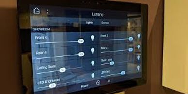 A smart home lighting control panel on a wall screen.