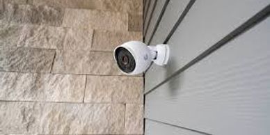 Security camera mounted on the exterior wall of a building.