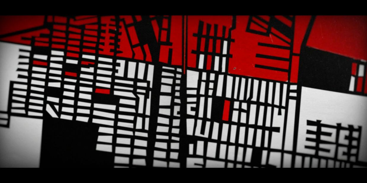 Abstract geometric artwork with black, white, and red rectangular patterns.