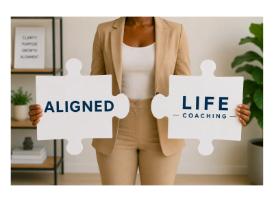 Person holding puzzle pieces with 'Aligned Life Coaching' text.