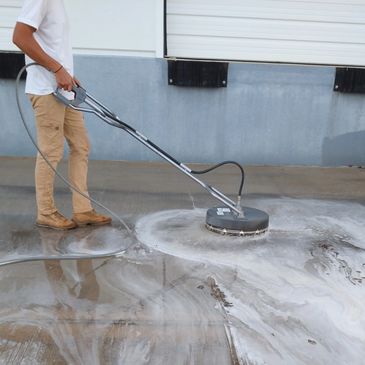 Cypress Striping & Power Washing Team pressure washing commercial parking area in Houston, TX