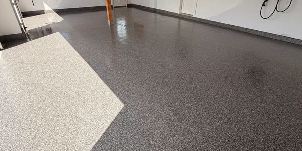 A garage floor with a decorative epoxy coating in two shades.