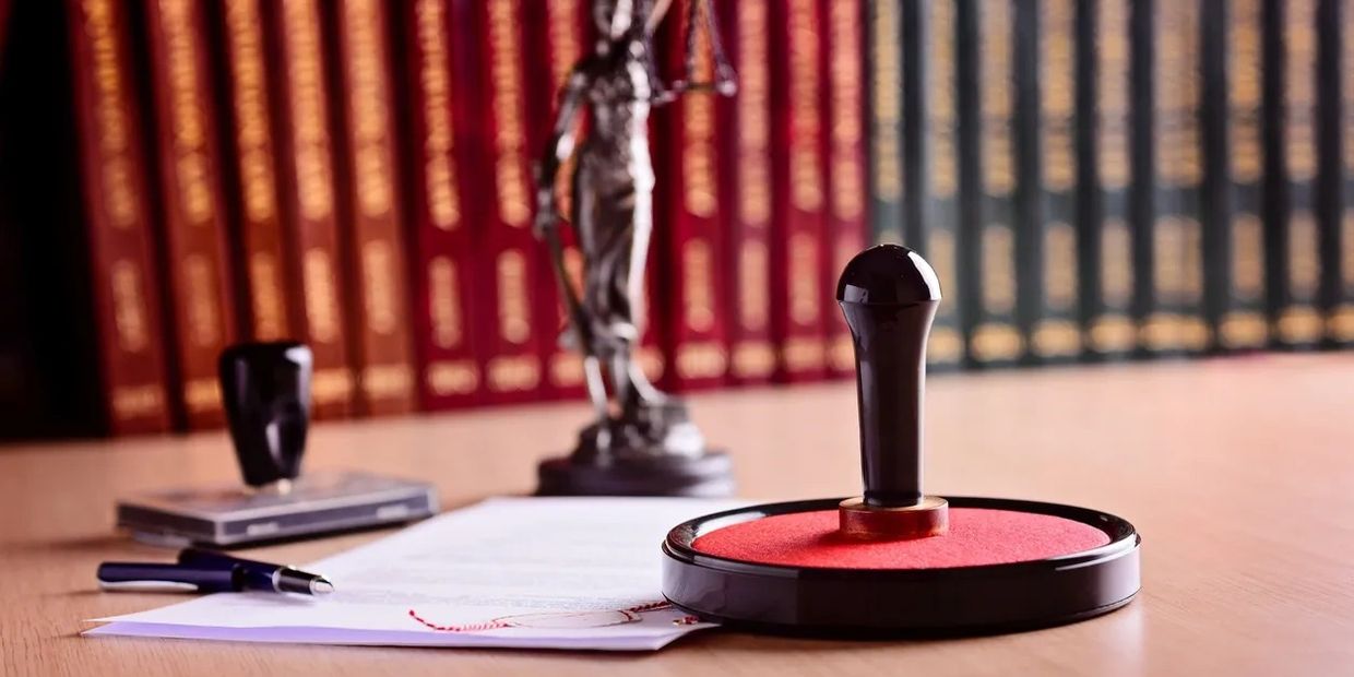 Books on a table with a notary stamp, pen, and paper, symbolizing professional notary service