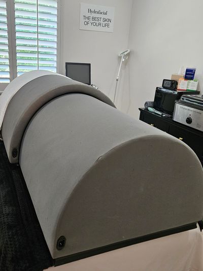 A modern spa treatment bed in a clean, minimalistic room.