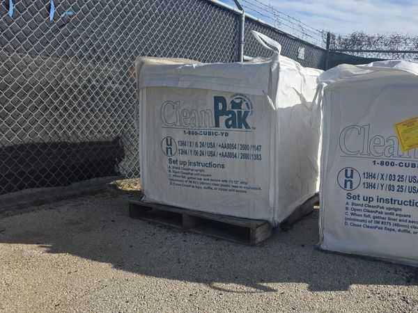 Large white CleanPak bags for hazardous waste.