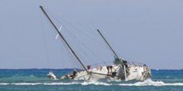 Sailboat wrecked on reef. 