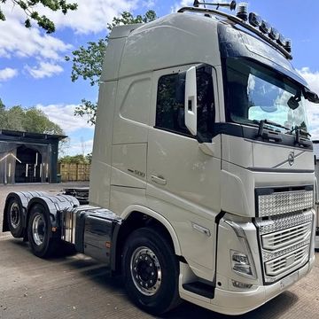White Volvo semi-truck cab under blue sky.