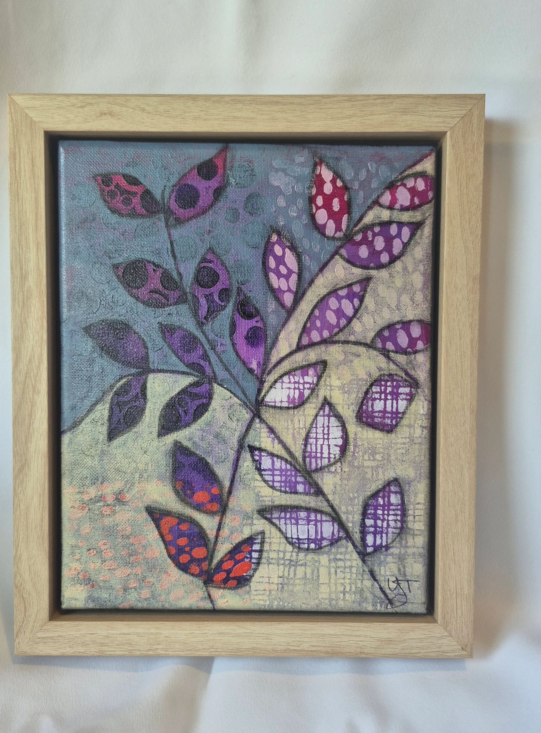 Framed abstract painting featuring vibrant purple and red leaves.