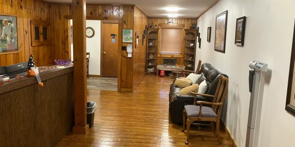Cozy wooden hallway with seating and shelves in a home.