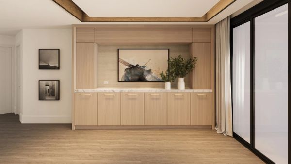 Modern wooden cabinet with artwork and plants beside glass doors.