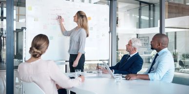 Shot of a mature businesswoman delivering a presentation to her colleagues in a modern office.