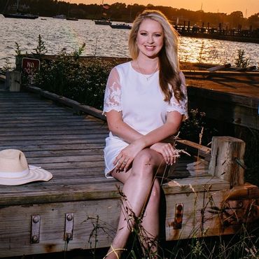 Future Mrs. sitting on a dock by the water. 