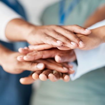 Team huddle with overlapping hands