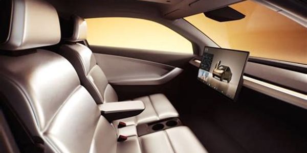 Modern car interior with leather seats and digital screen.