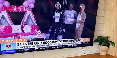 Indoor slumber party setup and hosts in animal pajamas.