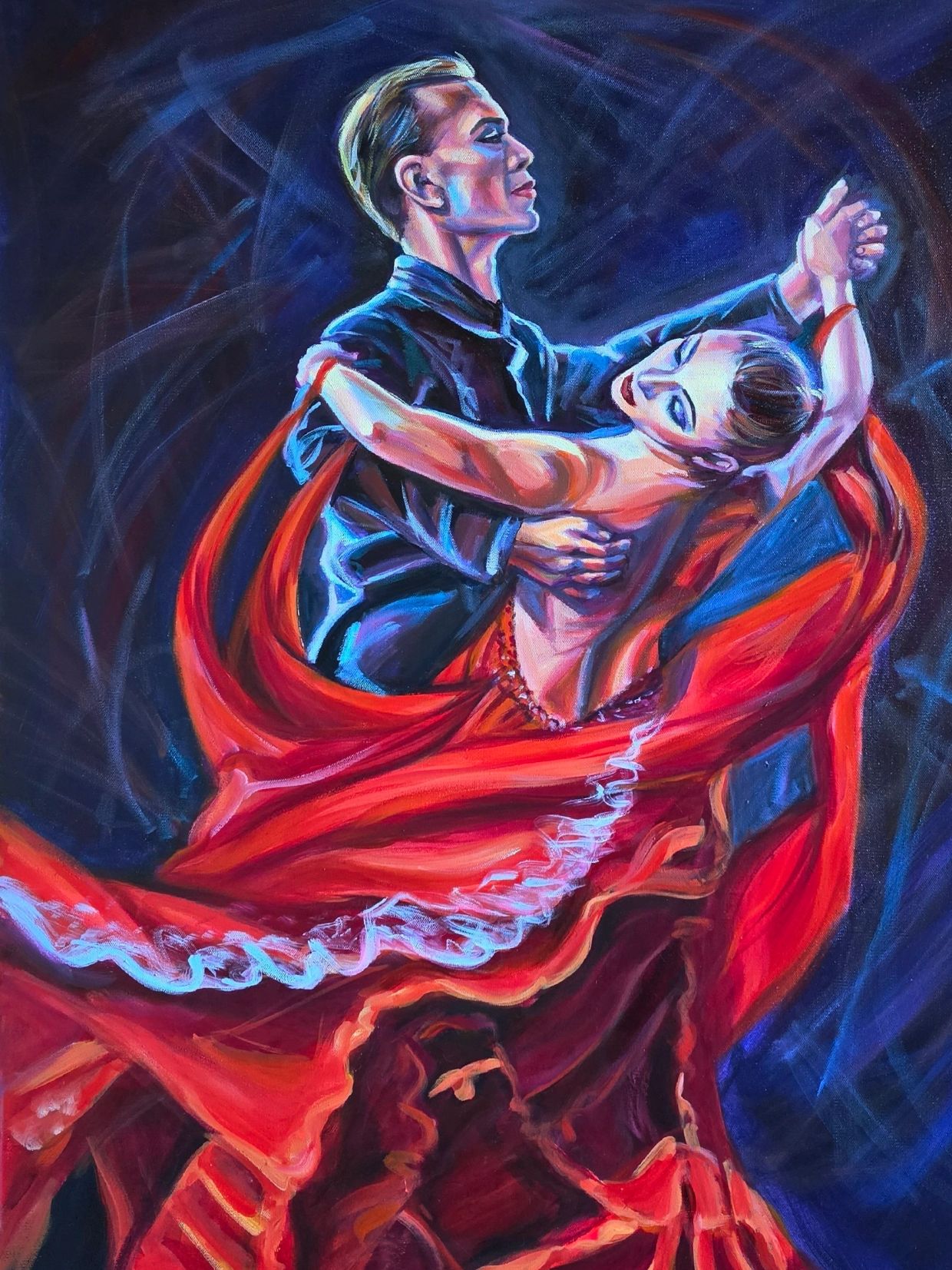 Couple passionately dancing with flowing red dress.