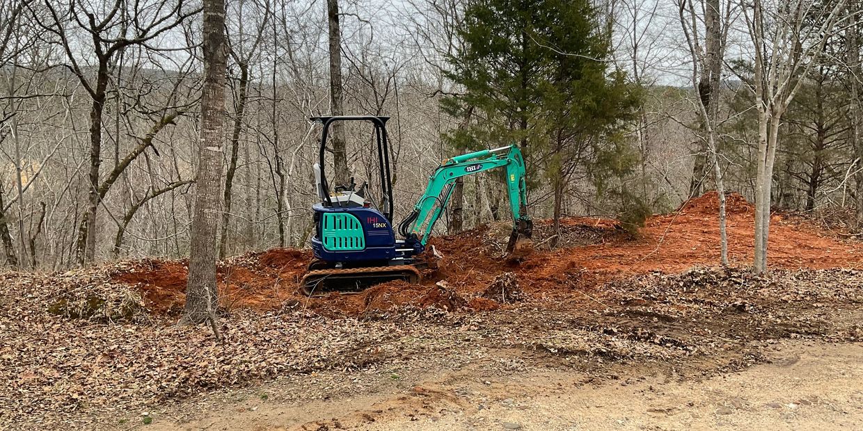 Blue Excavator Clearing Land