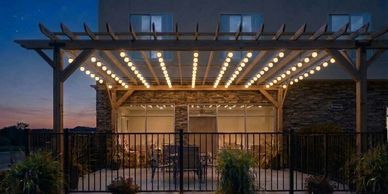Backyard patio with string lights at dusk.