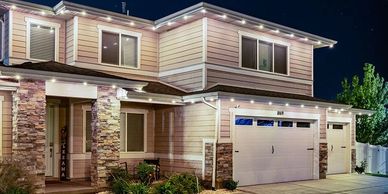 Modern two-story house illuminated at night.