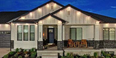 Modern well-lit single-story house exterior at dusk.