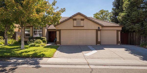 A house with two garage doors and a driveway.
