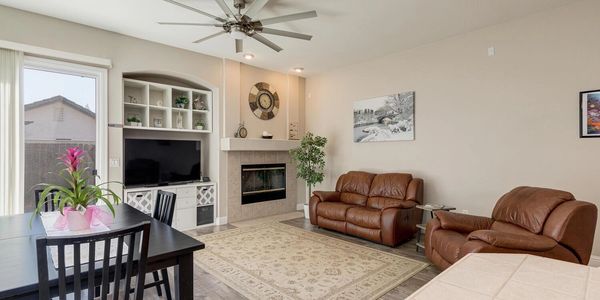 A living room with a fireplace and a tv.