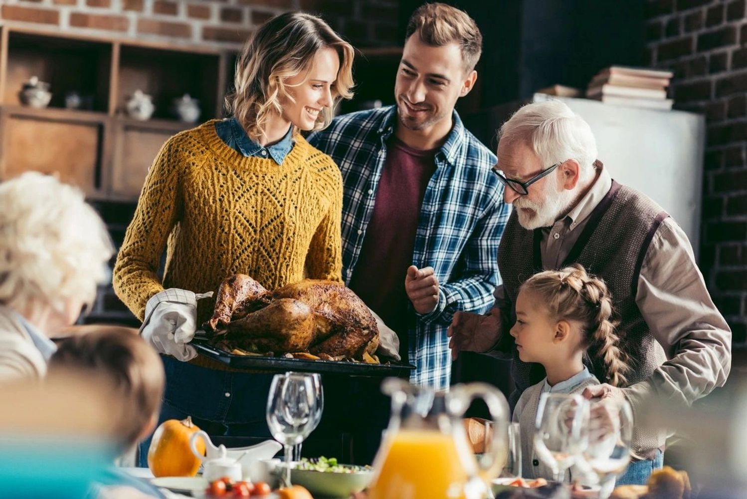 Four people looking at the newly cooked chicken