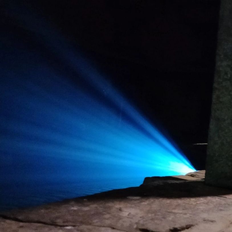 Blue light beam in dark space.