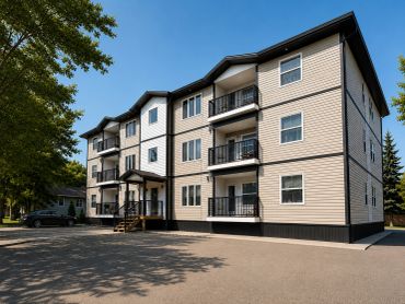 Modern three-story apartment building with balconies.