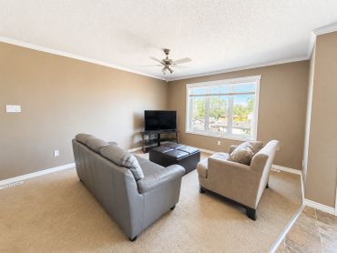 Minimalist living room with gray couch and armchair.