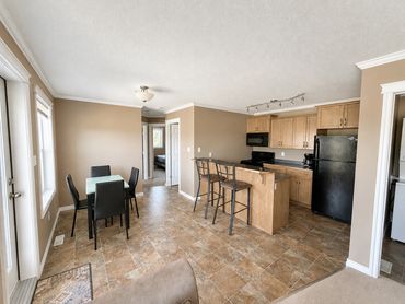 Modern kitchen and dining area with a neutral color scheme.