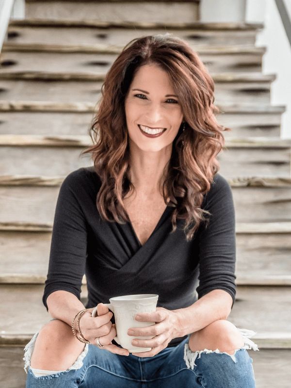 Shannon Martel, business and course creation mentor, smiling while seated with a coffee cup
