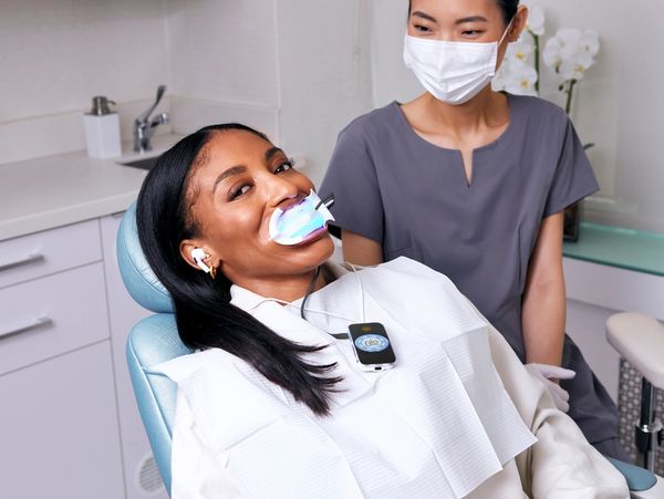 A dentist looking at her patient in her chamber