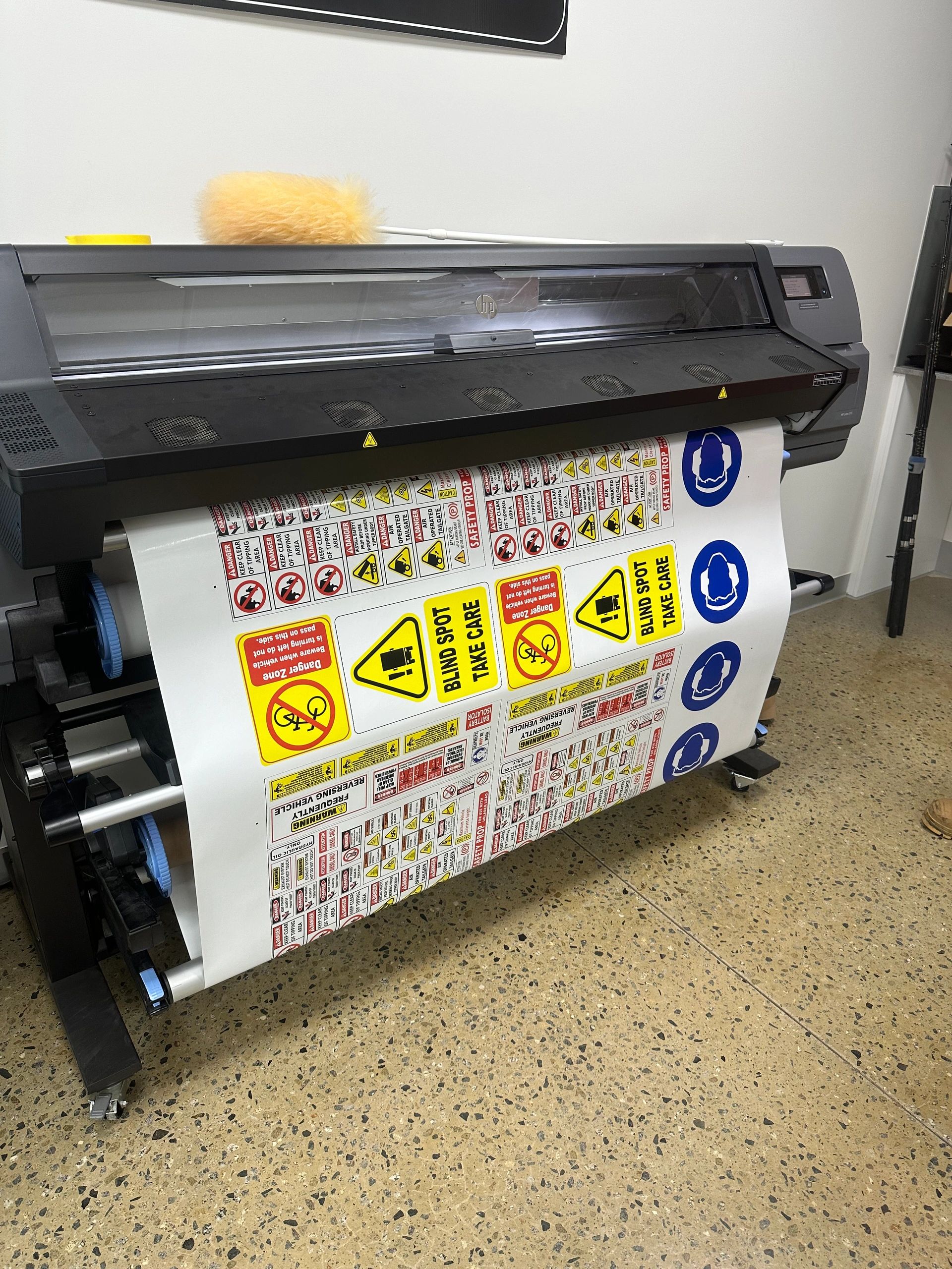 Large printer printing multiple safety signs.