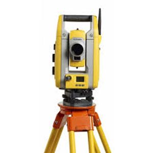 Yellow and orange surveying total station on tripod stand.