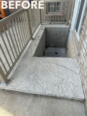 Concrete area with cracks and rough texture beside a basement window well.
