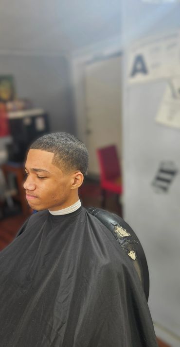 Young man with fresh haircut in a barbershop.