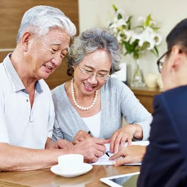 Senior couple meeting with Medicare broker looking at Medicare advantage part c and medigap plan