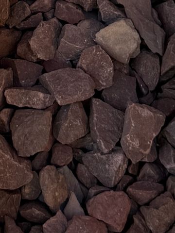 Close-up of rough reddish-brown stones piled together.
