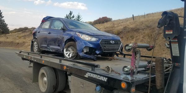 Damaged Vehicle On Tow Truck