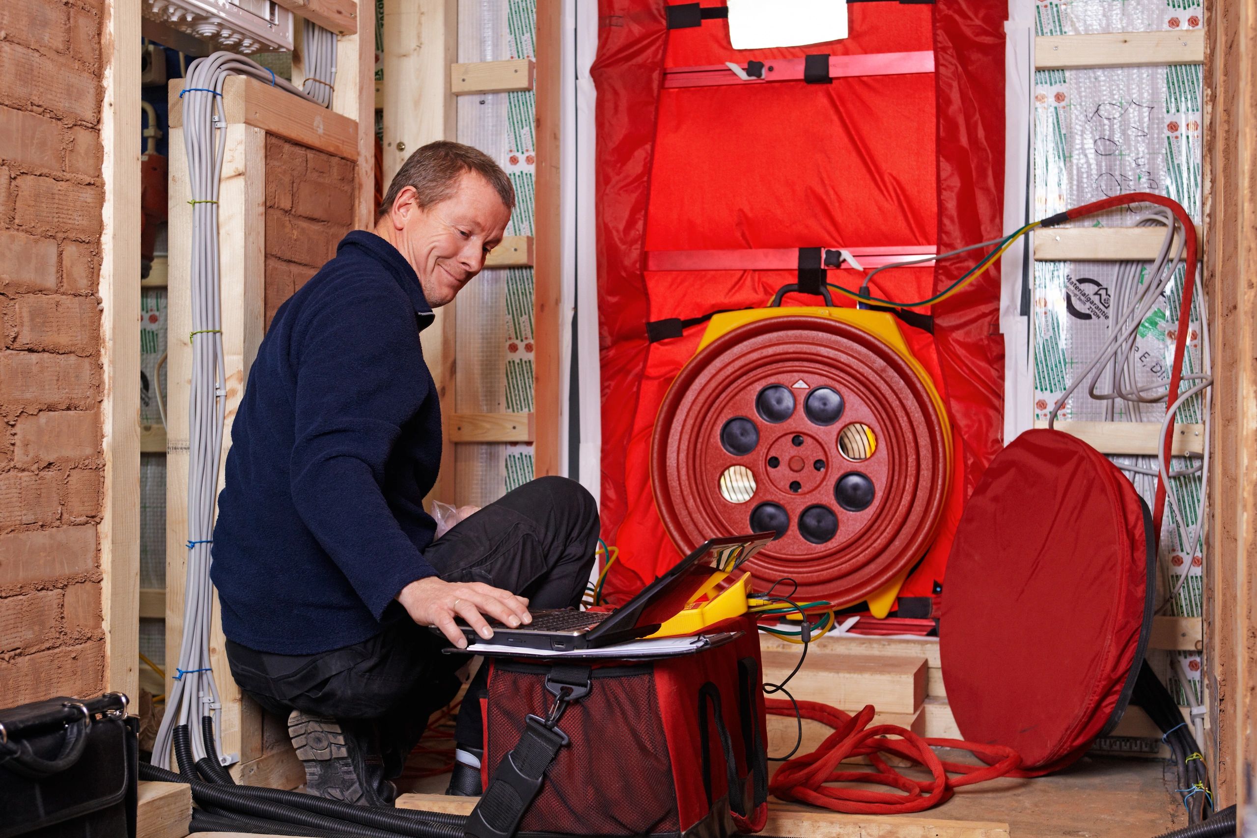 Man, performing a Blower Door test.