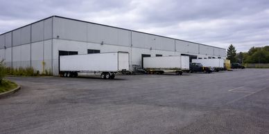 Loading dock with multiple trucks parked beside a warehouse building.