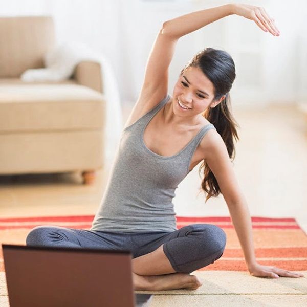 Woman stretching arm in front of computer