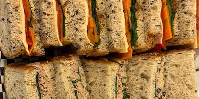 Multiple sandwiches with multigrain bread and vegetables.