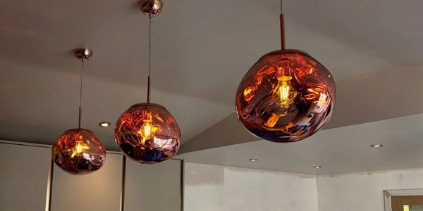 Three modern amber pendant lights hanging from the ceiling.