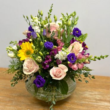 Fresh flower arrangement of roses, lilies, and stock for elegant décor.