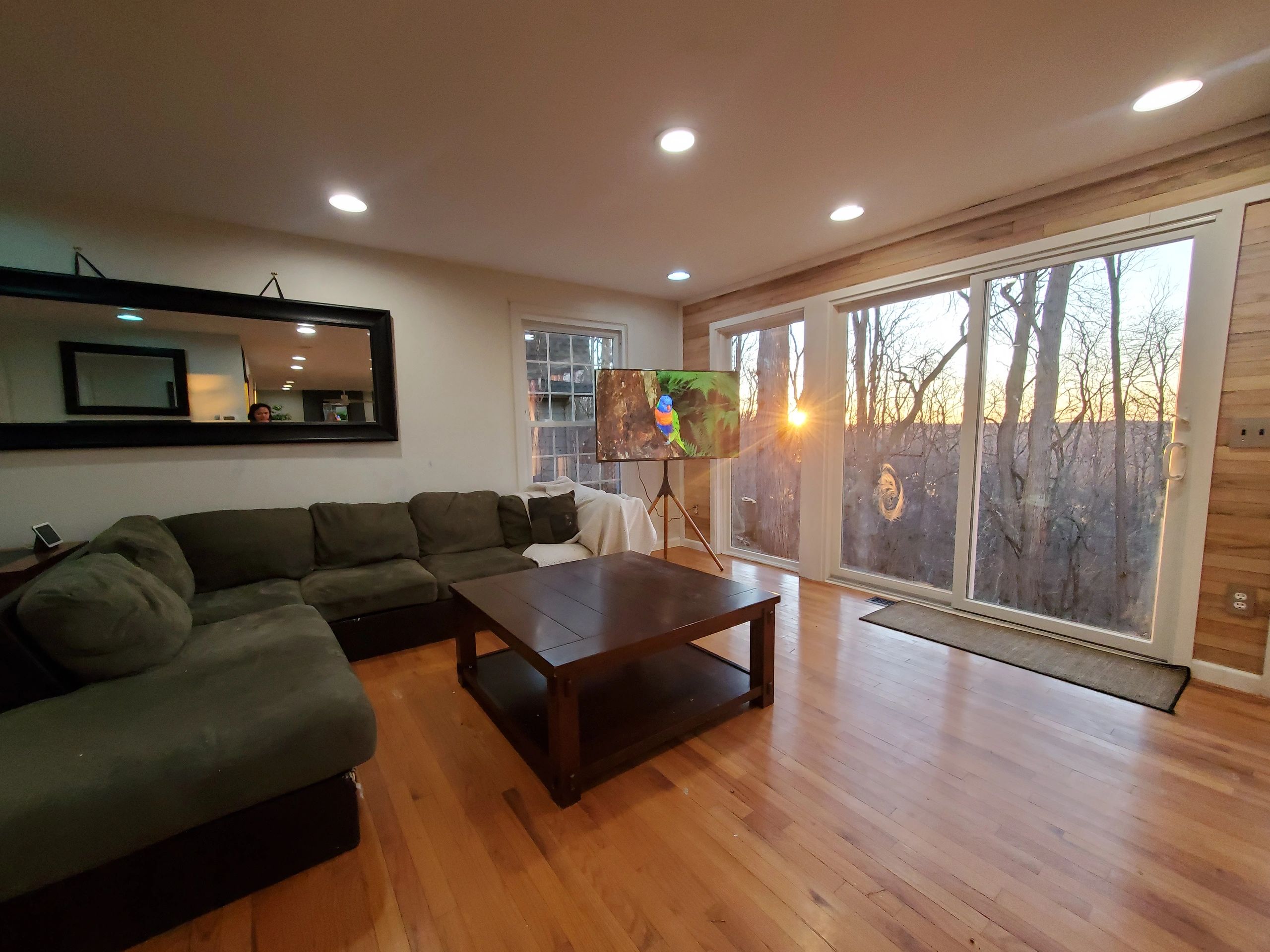 Cozy living room with large windows and sunset view.