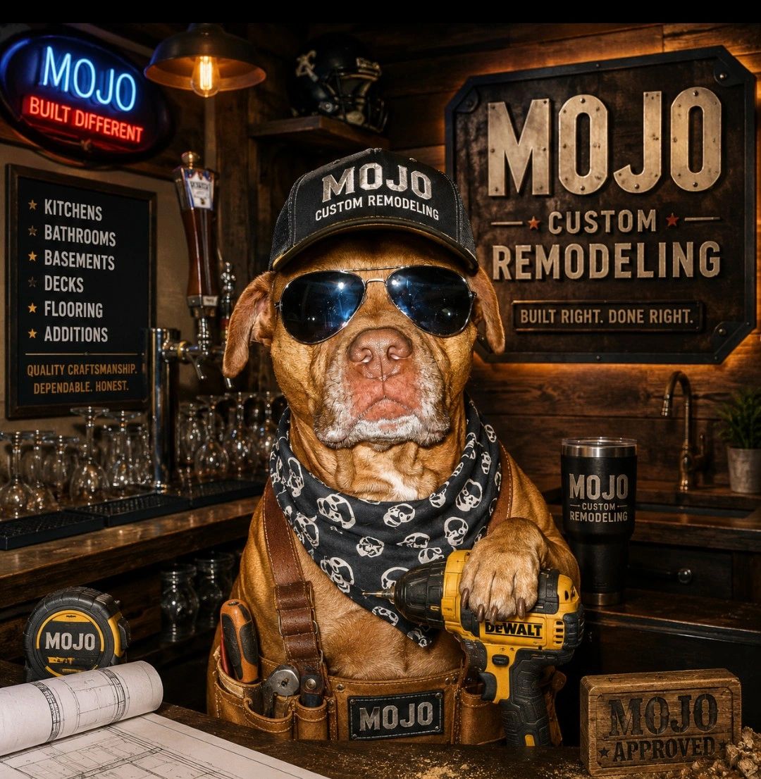 Dog in sunglasses,hat and scarf sitting in front of signs that say mojo custom remodeling services 