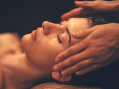 craniosacral session as the therapist cradles clients head. Michael Noonan LMT Massage, Exeter