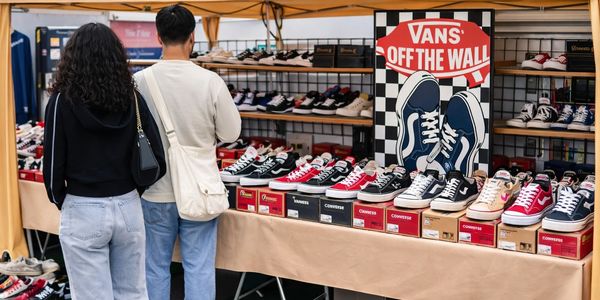 “Outdoor sneaker booth with Vans and Converse at a San Diego swap meet.”